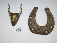 An old horseshoe, 4 1/2" x 4 1/8", and a brass head of a bull.