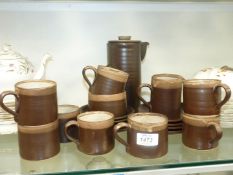 A brown stoneware coffee set for eight persons.