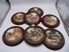 A quantity of Wedgwood for Bradex display plates in wooden frames including 'Fetching the Water',