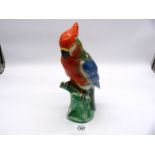 A Parrot ornament Made in Germany in green, red and blue colours, 9 3/4" tall.