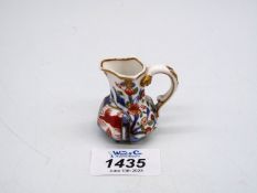 A fine and rare early 19th century miniature porcelain hydra jug, the base marked 'Spode',
