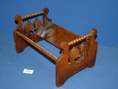 An Oak book trug with stylised heads having bobbin work to the ends.