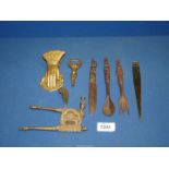 A carved wood knife, fork and spoon, brass bottle opener, nutcracker, paper knife, etc.