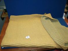 A Welsh wool waffle blanket, single, green and yellow.