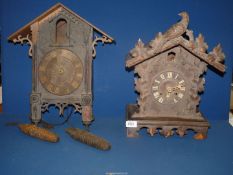 Two carved Cuckoo Clocks, for restoration, with two weights.