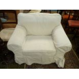 A cream upholstered Fireside Chair having corded off white loose fabric covers.