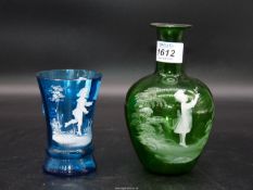 Two pieces of Mary Gregory glass including green bottle with boy and flower and small clear glass