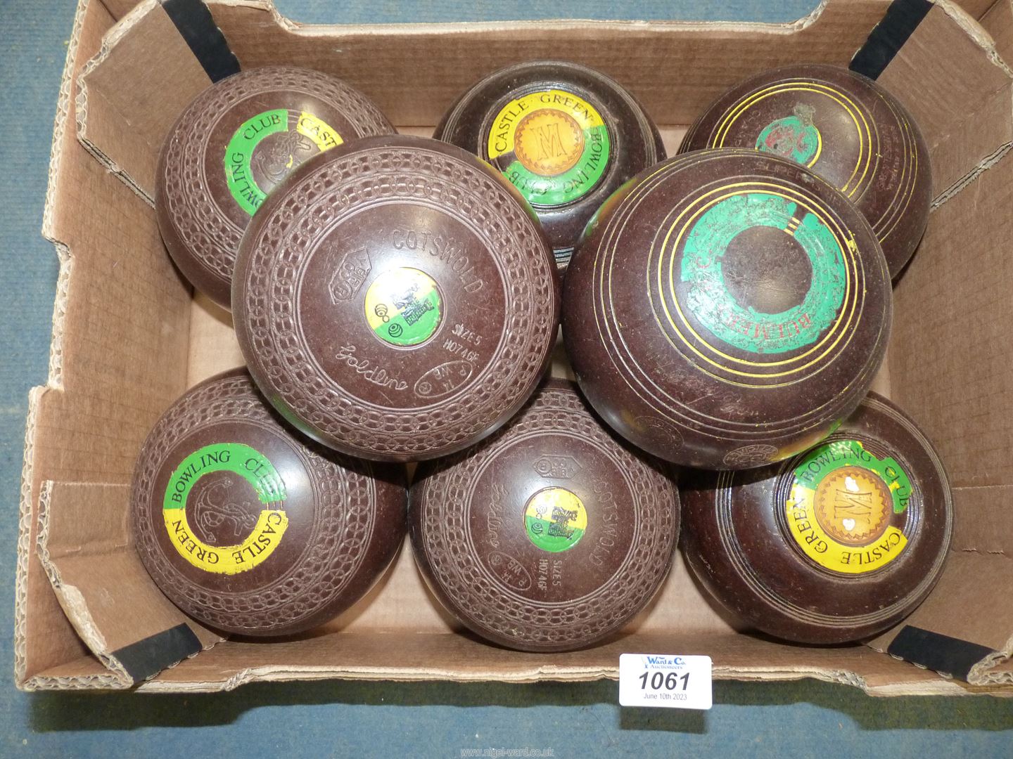 Two sets of Lawn Bowls, both brown, one with interlinked circle detail