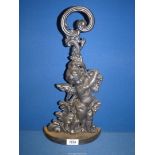 A vintage cast iron Doorstop in the form of a putto amidst foliage, 17'' tall.