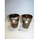 A pair of Horn beakers with small silver plaques with monograms on and silver rims, no hallmarks.