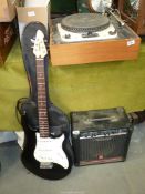 A Peavey electric guitar in case with a Peavey Rage 158 amplifier.