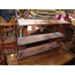 An Arts & Crafts free standing or wall hanging set of Mahogany shelves having intricately