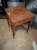 An Edwardian Mahogany/Walnut Envelope Table opening to reveal a card table lined with green baize