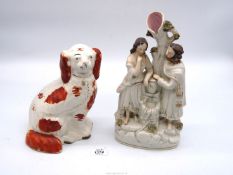 A Staffordshire flatback figural group of a man and woman standing by an urn,
