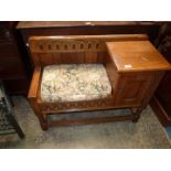 A Priory Oak/old charm type telephone seat having a recessed panelled doored cupboard to the side