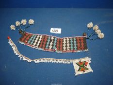 An old Zulu traditional bead work arm band with wood toggles,