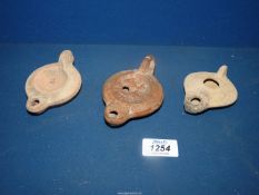 Antiquities: three ancient terracotta oil lamps.