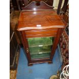 A Mahogany Music Cabinet having a glazed door and with green velvet lined shelves having two marked