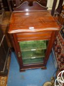 A Mahogany Music Cabinet having a glazed door and with green velvet lined shelves having two marked