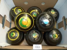 Two sets of Lawn Bowls, one by Drakes Pride Professional, size SM, the other marks rubbed.