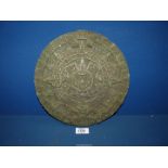 An Aztec style calendar with label guide to the reverse,