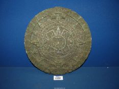 An Aztec style calendar with label guide to the reverse,