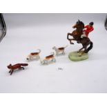 Three Beswick hound figures and a Beswick fox and a Huntsman on a rearing horse, damage to boot.