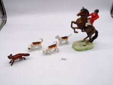 Three Beswick hound figures and a Beswick fox and a Huntsman on a rearing horse, damage to boot.