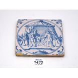 A scarce 17th century Dutch Delft tile depicting Judith standing in her tent with the head of