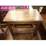 A dark Oak rectangular Occasional Table having curved corners and standing on square legs with