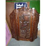 A folding Firescreen in carved wood with lattice, bird, floral and foliage detail.