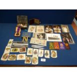 An old money box and contents including badges for Lilliput Collectors Club, St.