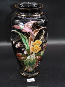 A black glass vase with painted bird and floral decoration, some wear to the rim, 15'' tall.