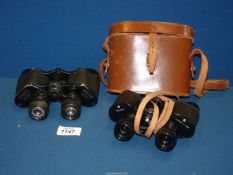 A pair of Dolland binoculars (8 x 25) and a pair of Otto Walter binoculars (8 x 34).