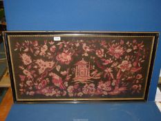 A large mid 19th century Woolwork depicting an oriental pagoda surrounded by exotic birds,
