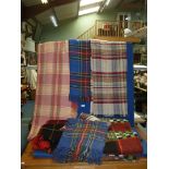 A quantity of travel rugs and picnic blankets.