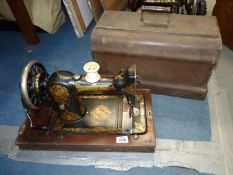 A Jones hand sewing machine with colourful decoration, case a/f.