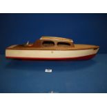 A wooden model of a vintage motorboat "Maggie" with a propeller,