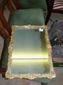 A Wall mirror with elaborate gilded frame, 22'' x 16'', a/f.