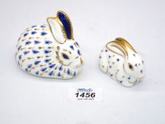 Two Royal Crown Derby paperweights in the form of a rabbit and baby rabbit,