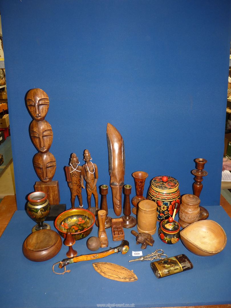 A quantity of treen including an oak candlestick, a tribal figure, a dice box, etc.