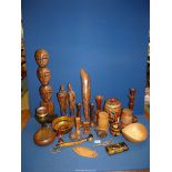 A quantity of treen including an oak candlestick, a tribal figure, a dice box, etc.
