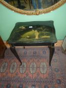 A black lacquered rectangular occasional Table standing on cabriole legs and having chinosierie
