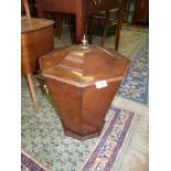 An octagonal shaped Mahogany wine cooler/coal bucket with lid and having brass loop handles,