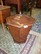 An octagonal shaped Mahogany wine cooler/coal bucket with lid and having brass loop handles,