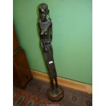 A large ebonised carving of a Tribal woman, 42" tall.