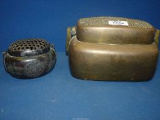 A small 19th century Chinese bronze hand warmer, finely incised with floral designs,