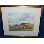 A framed and mounted Watercolour of a lake scene with hills in the distance, signed lower right 'I.