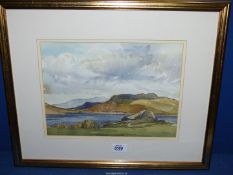 A framed and mounted Watercolour of a lake scene with hills in the distance, signed lower right 'I.