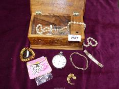 A quantity of costume jewellery in a wooden musical box, bracelets, beads, earrings etc.
